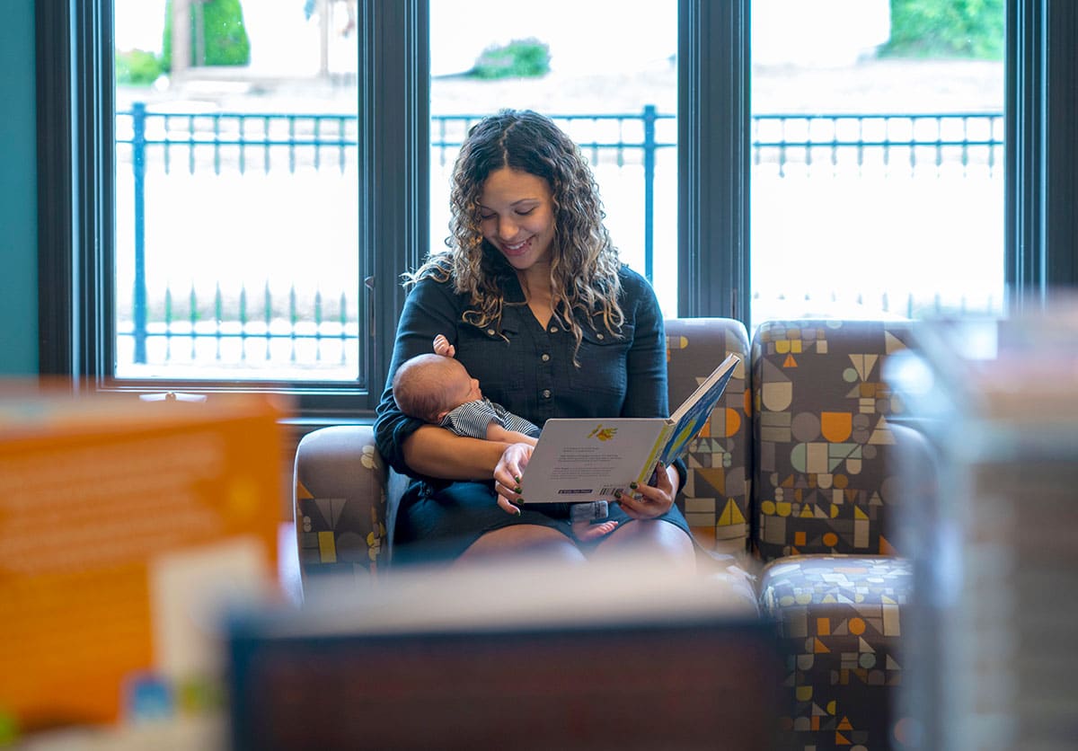 Mother reading to her baby in the library