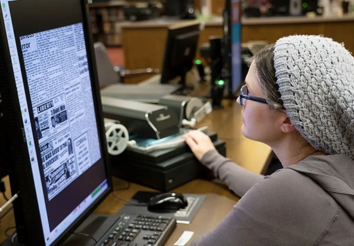 Woman researching digital newspapers at VCPL